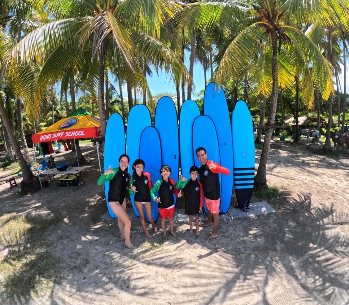 Family ready for a group surf lesson at Indio Surf School in Playa Sámara, Costa Rica