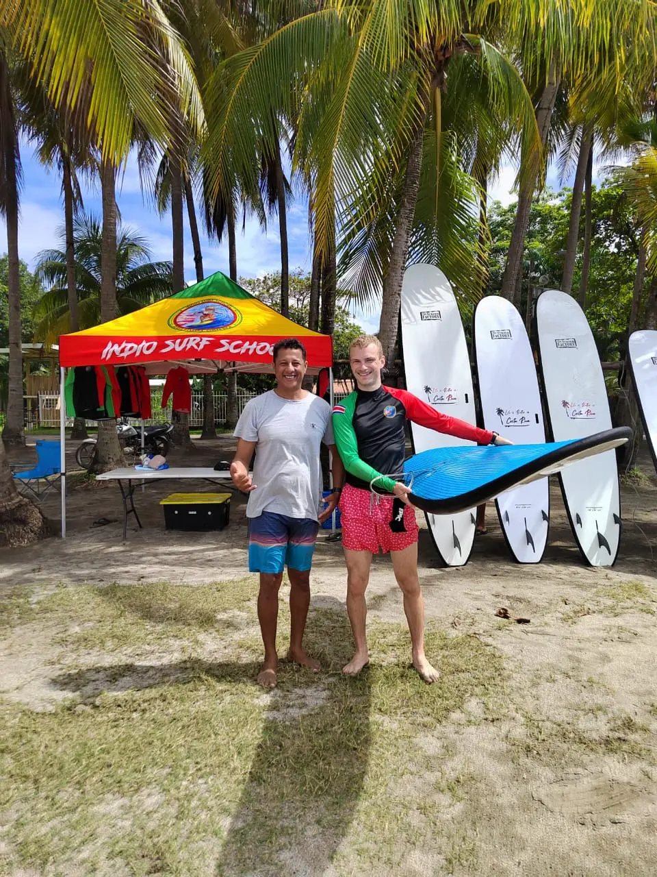 Surf instructor and student with surfboards at Indio Surf School, Playa Sámara, Costa Rica