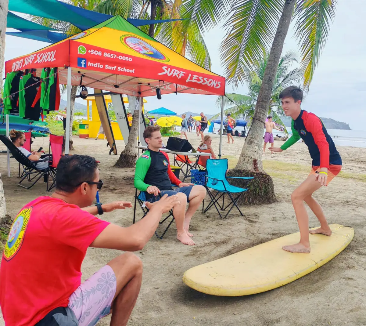 Surf instructor teaching the pop-up to a student at Indio Surf School, Playa Sámara