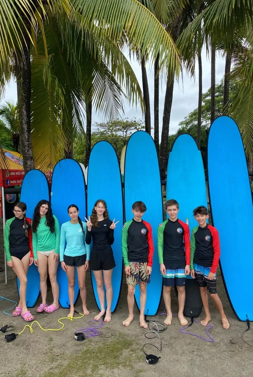 Group of teens with surfboards before a lesson at Indio Surf School, Playa Sámara